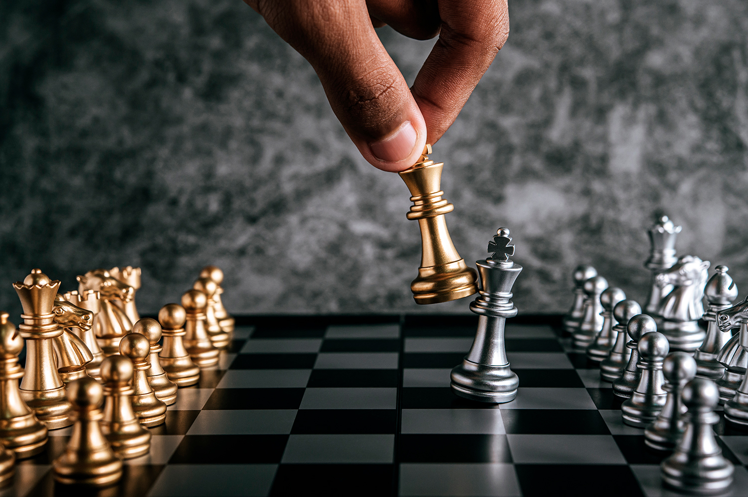 https://merradisgroup.com/wp-content/uploads/2021/12/hand-man-playing-chess-business-planning-comparison-metaphor-selective-focus.jpg